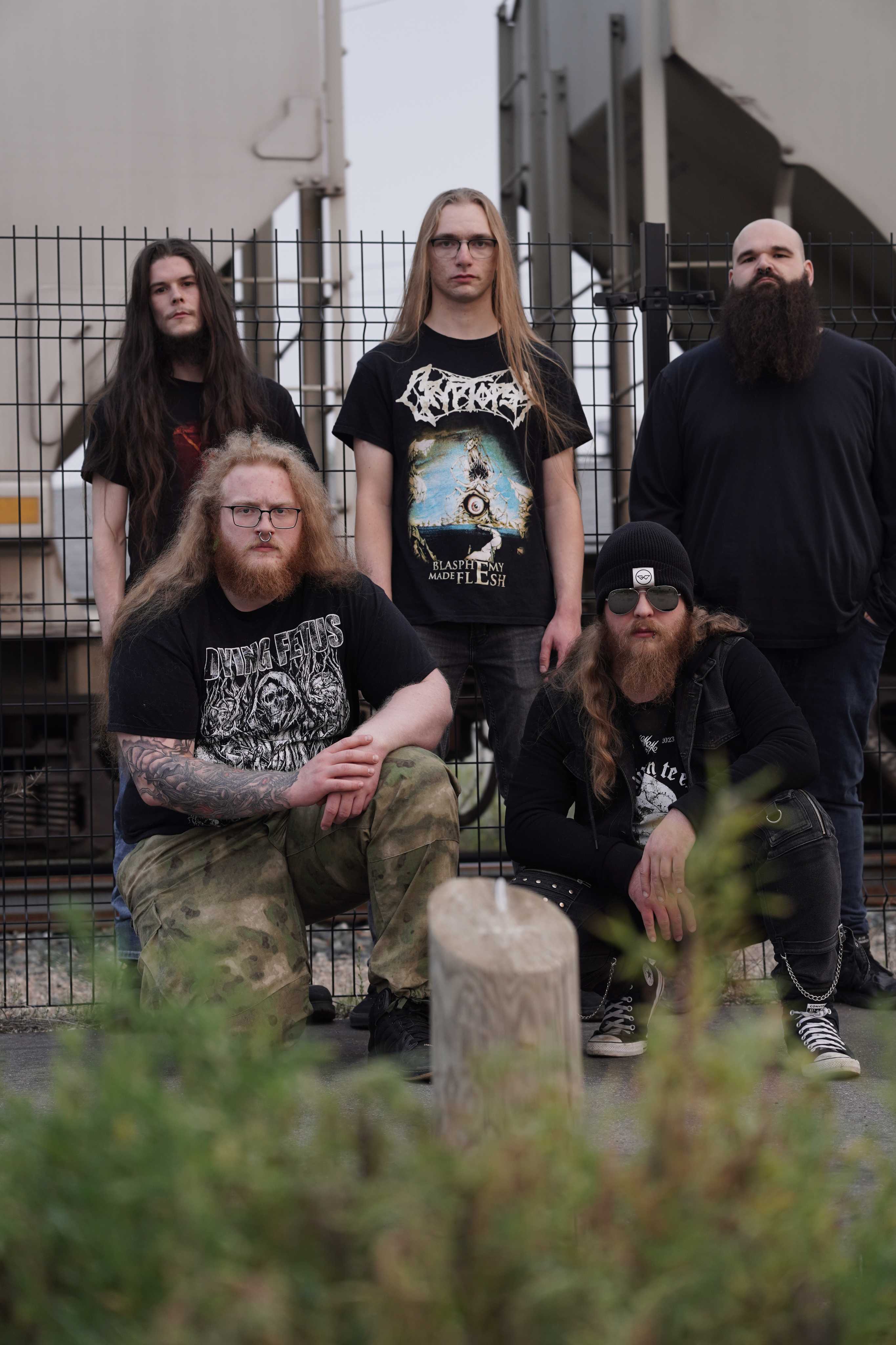 A portrait of the Pythonic band members posing in front of a train